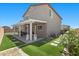 Landscaped backyard featuring a covered patio, manicured lawn and decorative stone features at 9054 Tangerine Tree Ct, Las Vegas, NV 89113