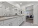 Bathroom featuring double sinks with granite countertops, modern cabinetry and a large mirror at 9054 Tangerine Tree Ct, Las Vegas, NV 89113