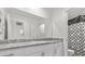 Modern bathroom with granite countertops, white cabinets, and a patterned shower curtain at 9054 Tangerine Tree Ct, Las Vegas, NV 89113