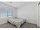 The simple bedroom has neutral carpet and walls, and the window offers natural light at 9054 Tangerine Tree Ct, Las Vegas, NV 89113