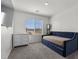 Cozy bedroom featuring a blue daybed, gray dresser, and scenic view from the window at 9054 Tangerine Tree Ct, Las Vegas, NV 89113