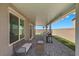 Enjoy the covered patio with tiled flooring, a grill, and comfortable seating for outdoor relaxation at 9054 Tangerine Tree Ct, Las Vegas, NV 89113