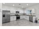 Clean kitchen featuring stainless steel appliances, granite countertops, and tile flooring at 9054 Tangerine Tree Ct, Las Vegas, NV 89113