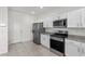 Well-lit kitchen showcasing stainless steel appliances, granite countertops, and white cabinets at 9054 Tangerine Tree Ct, Las Vegas, NV 89113
