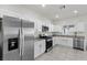 Bright kitchen featuring stainless steel appliances, granite countertops, and white cabinetry at 9054 Tangerine Tree Ct, Las Vegas, NV 89113