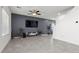Spacious living room with tile floors, a modern entertainment center, and ample natural light at 9054 Tangerine Tree Ct, Las Vegas, NV 89113