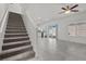 Open-concept living space with tile floors, sliding glass doors, and a staircase at 9054 Tangerine Tree Ct, Las Vegas, NV 89113