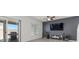 Comfortable living room with tile floors, sliding glass doors, and a stylish entertainment center at 9054 Tangerine Tree Ct, Las Vegas, NV 89113