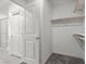 Spacious walk-in closet with ample storage space with a door leading to an ensuite bathroom at 9054 Tangerine Tree Ct, Las Vegas, NV 89113