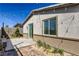 A backyard boasting a wooden deck, stone accents, landscaping, and overhead string lights at 9351 Aria Ridge Ave, Las Vegas, NV 89143