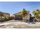 Single-story home with two car garage, a brick paved driveway, and desert landscaping at 9351 Aria Ridge Ave, Las Vegas, NV 89143