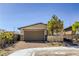 Charming single-story home with a neutral color scheme, brick driveway, and a two car garage at 9351 Aria Ridge Ave, Las Vegas, NV 89143