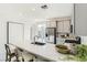 Stylish kitchen featuring a large island with seating, stainless steel appliances, and bright lighting at 9351 Aria Ridge Ave, Las Vegas, NV 89143