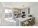 Modern kitchen with stainless steel appliances, an island with seating, and sliding glass doors at 9351 Aria Ridge Ave, Las Vegas, NV 89143
