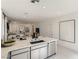 Modern kitchen with stainless steel appliances seamlessly flows into the dining and living areas at 9351 Aria Ridge Ave, Las Vegas, NV 89143