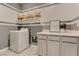 Functional laundry room with cabinets, counter space, and washer at 9351 Aria Ridge Ave, Las Vegas, NV 89143