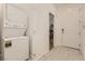 Hallway laundry area with stacked washer and dryer and doorway leading to the living spaces at 9351 Aria Ridge Ave, Las Vegas, NV 89143