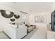 Bright living room boasting neutral color scheme, modern furniture, and wood tile floors at 9351 Aria Ridge Ave, Las Vegas, NV 89143