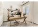 Home office with a rustic wooden desk and storage shelving at 9351 Aria Ridge Ave, Las Vegas, NV 89143
