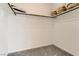 Walk-in closet featuring a closet rod, upper shelf with storage baskets and neutral carpet at 9351 Aria Ridge Ave, Las Vegas, NV 89143