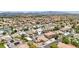 Expansive aerial view of neighborhood featuring pool, and solar panels in a desert landscape, highlighting community living at 9410 Stone Castle Way, Las Vegas, NV 89123