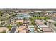 Wide aerial perspective of a residential area near a school, displaying diverse home styles and landscaping at 9410 Stone Castle Way, Las Vegas, NV 89123