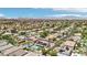 Sweeping aerial image of a residential area with pools, solar panels, and meticulously maintained landscaping at 9410 Stone Castle Way, Las Vegas, NV 89123