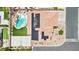 Aerial shot showcasing a home with a pool, spa, basketball court, solar panels, and manicured landscaping at 9410 Stone Castle Way, Las Vegas, NV 89123