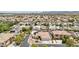 Scenic aerial shot of a residential area featuring tile-roofed houses, solar panels, and lush landscaping at 9410 Stone Castle Way, Las Vegas, NV 89123