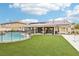 Expansive backyard featuring a pool, sport court, well maintained turf, and ample space for entertaining at 9410 Stone Castle Way, Las Vegas, NV 89123
