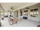 Covered patio with a dining table, ceiling fans, and a view of the beautiful backyard and pool at 9410 Stone Castle Way, Las Vegas, NV 89123