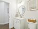 Clean and modern bathroom featuring a vanity with a round mirror and neutral decor, offering a serene space at 9410 Stone Castle Way, Las Vegas, NV 89123