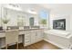 Bright bathroom features a large vanity and a fireplace over a corner bathtub at 9410 Stone Castle Way, Las Vegas, NV 89123