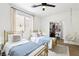Bright bedroom with two beds, closet, and ceiling fan, offering a comfortable and functional living space at 9410 Stone Castle Way, Las Vegas, NV 89123