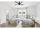 Bright bedroom with two beds, accent rug, and bathroom access, creating a comfortable and functional space at 9410 Stone Castle Way, Las Vegas, NV 89123