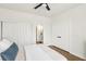 Neutral bedroom featuring white walls, wood-look flooring, and closet with sliding doors at 9410 Stone Castle Way, Las Vegas, NV 89123