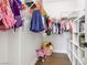 Walk-in closet with wood-look floors, clothing racks, shelving, and pink toys at 9410 Stone Castle Way, Las Vegas, NV 89123