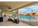 Relaxing covered patio overlooking the pool and backyard, perfect for outdoor living and entertaining at 9410 Stone Castle Way, Las Vegas, NV 89123