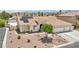 Well-maintained home features desert landscaping, a tile roof, and a spacious three-car garage at 9410 Stone Castle Way, Las Vegas, NV 89123