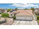 Charming single-story home with desert landscaping, tile roof and three-car garage at 9410 Stone Castle Way, Las Vegas, NV 89123