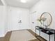 Bright foyer featuring white walls, a large entry door, and stylish decor, creating a welcoming atmosphere at 9410 Stone Castle Way, Las Vegas, NV 89123