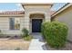 Inviting front entrance featuring double doors, desert landscaping, and a charming walkway at 9410 Stone Castle Way, Las Vegas, NV 89123