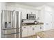 Modern kitchen boasting stainless steel appliances, white cabinets, and granite countertops at 9410 Stone Castle Way, Las Vegas, NV 89123