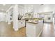 Open-concept kitchen with granite countertops, stainless steel appliances, and an island with barstool seating at 9410 Stone Castle Way, Las Vegas, NV 89123
