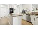 Bright kitchen island with granite countertops, stainless steel appliances, and white cabinetry at 9410 Stone Castle Way, Las Vegas, NV 89123