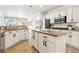 Spacious kitchen with granite countertops, stainless steel appliances, and white cabinetry at 9410 Stone Castle Way, Las Vegas, NV 89123