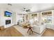 Cozy living room with fireplace, built-in shelving, and backyard views at 9410 Stone Castle Way, Las Vegas, NV 89123