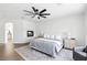Large primary bedroom with a fireplace and hardwood flooring at 9410 Stone Castle Way, Las Vegas, NV 89123