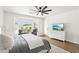 Bright primary bedroom suite with hardwood flooring, natural light, and a ceiling fan at 9410 Stone Castle Way, Las Vegas, NV 89123