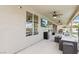 Covered patio features a mounted tv, ceiling fans, and stylish outdoor furniture perfect for entertaining at 9410 Stone Castle Way, Las Vegas, NV 89123
